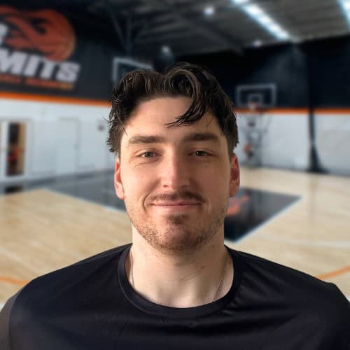 Basketball player smiling at No Limits Basketball indoor court in Australia.
