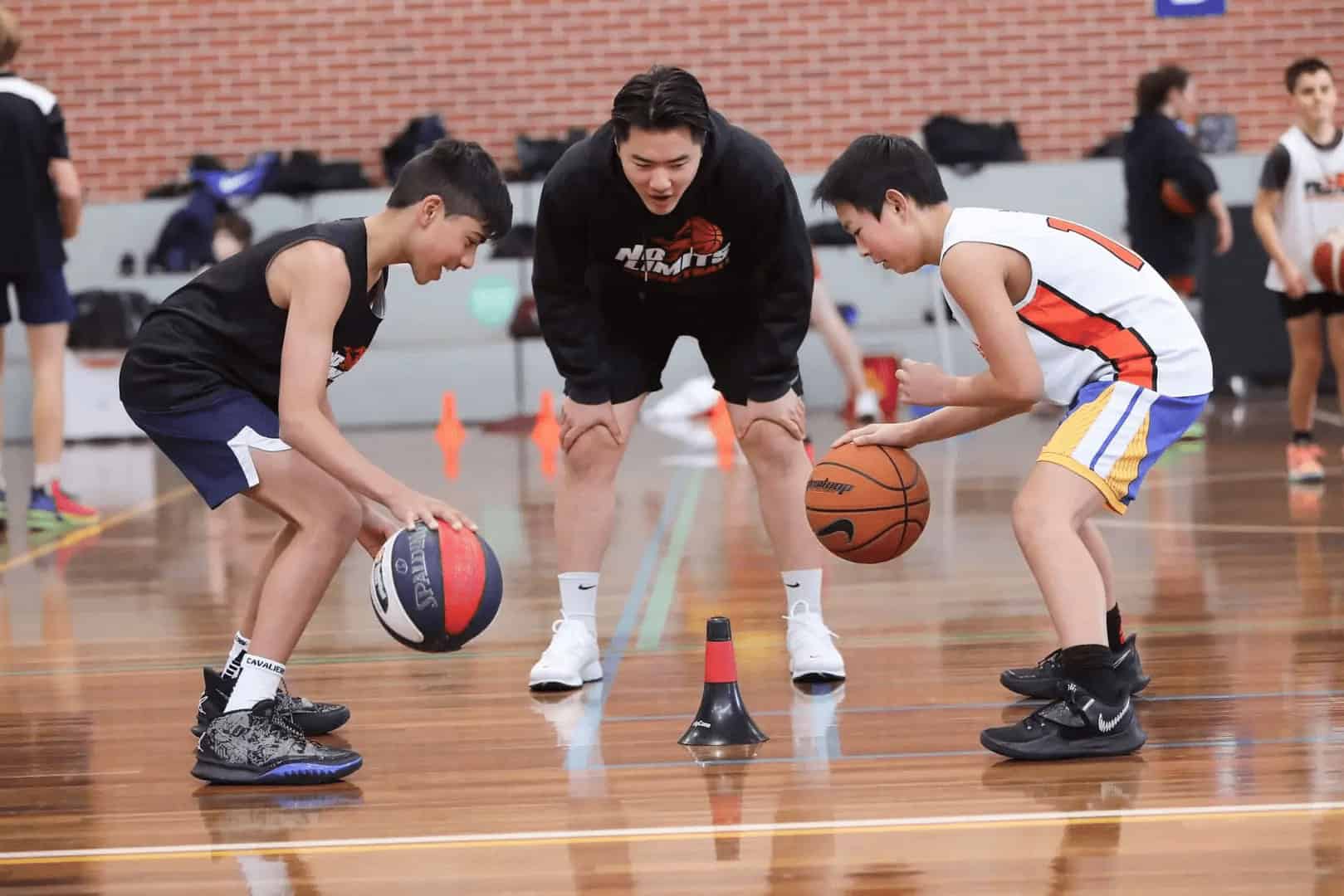 Young basketball players practicing dribbling drills at No Limits Basketball training session.