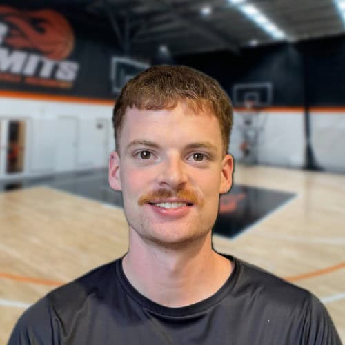 High school basketball player smiling in gymnasium, No Limits Basketball training session, sports, youth basketball.