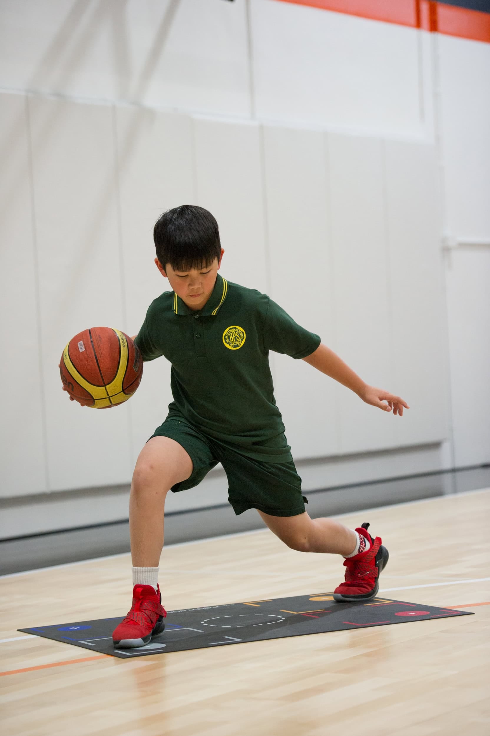 Young boy practicing basketball drills at No Limits Basketball in Australia.