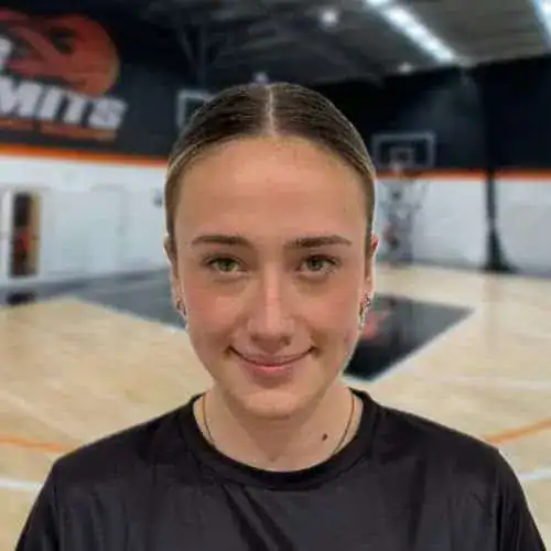 Young female basketball player at No Limits Basketball indoor court in Australia.