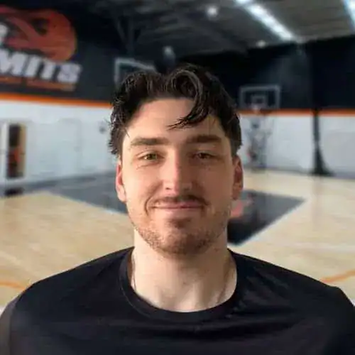 Portrait of a young man in a basketball gym at No Limits Basketball.
