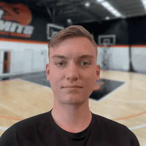 Young man in black shirt at No Limits Basketball indoor court.