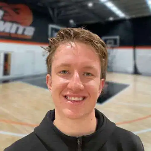 Young male basketball player smiling at No Limits Basketball gym.