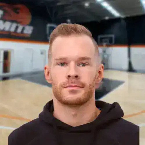 Man in black hoodie at No Limits Basketball indoor court in Australia.
